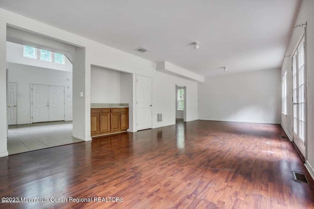 2557 Huckleberry Rd, Manchester, NJ 08759 - unfurnished living room featuring plenty of natural light, wood finished floors, and baseboards