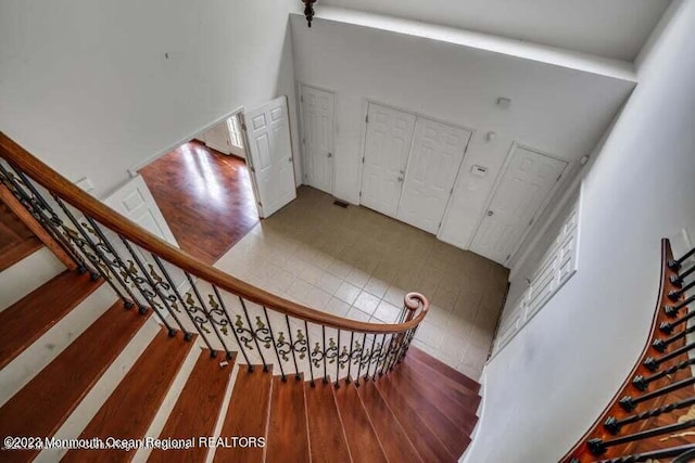 2557 Huckleberry Rd, Manchester, NJ 08759 - stairway with wood finished floors and a towering ceiling