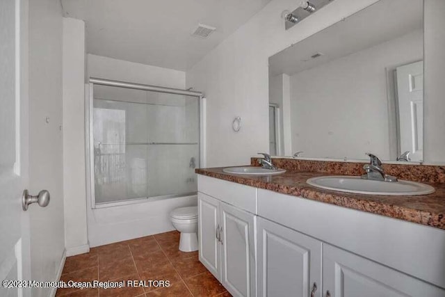 2557 Huckleberry Rd, Manchester, NJ 08759 - full bathroom with toilet, combined bath / shower with glass door, double vanity, and tile patterned floors