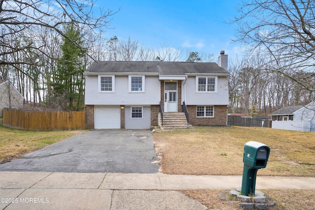 86 Buckingham Dr, Jackson, NJ 08527 - split foyer home featuring brick siding, asphalt driveway, a chimney, and an attached garage