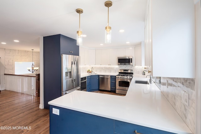 86 Buckingham Dr, Jackson, NJ 08527 - kitchen with appliances with stainless steel finishes, blue cabinets, a sink, tasteful backsplash, and light countertops