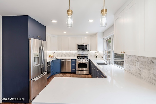86 Buckingham Dr, Jackson, NJ 08527 - kitchen featuring appliances with stainless steel finishes, a sink, blue cabinetry, light countertops, and recessed lighting