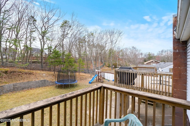 86 Buckingham Dr, Jackson, NJ 08527 - wooden terrace with a trampoline and a playground