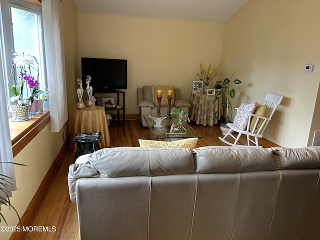 living room with wood finished floors and baseboards