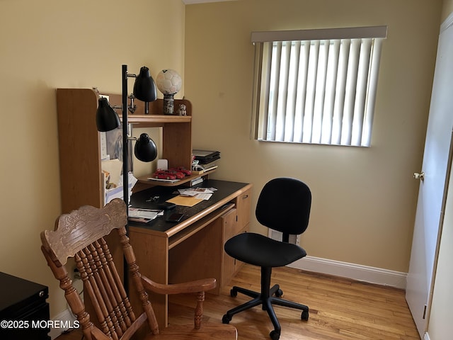 office space with wood finished floors and baseboards