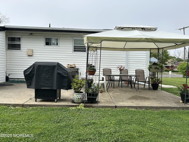 rear view of property featuring a patio, a yard, and a gazebo