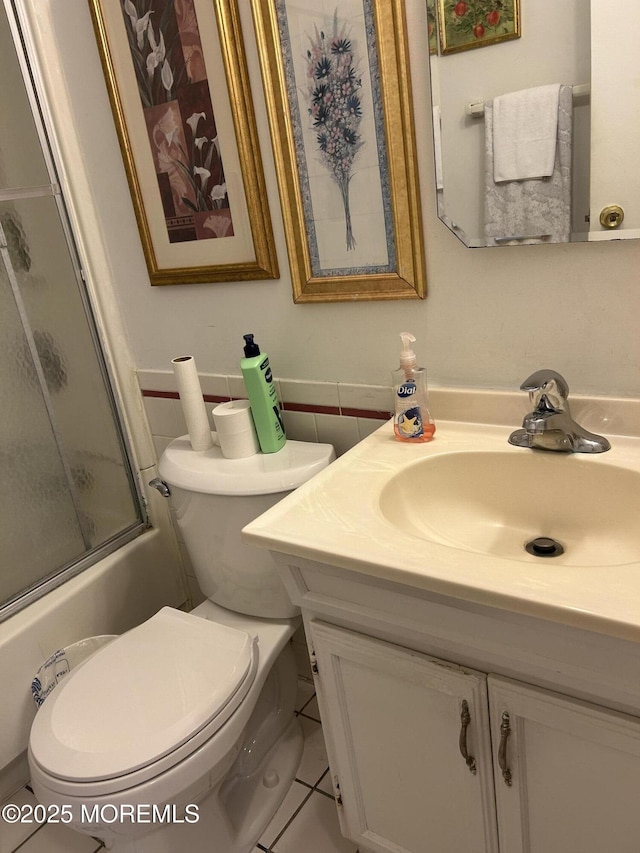 full bath with toilet, vanity, enclosed tub / shower combo, and tile patterned floors