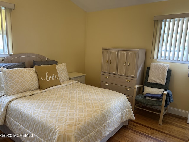 bedroom featuring wood finished floors and baseboards