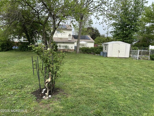 view of yard featuring a shed and an outdoor structure