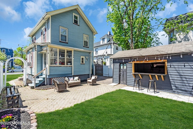 rear view of house featuring a patio area, outdoor lounge area, and entry steps