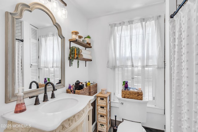bathroom featuring toilet and vanity