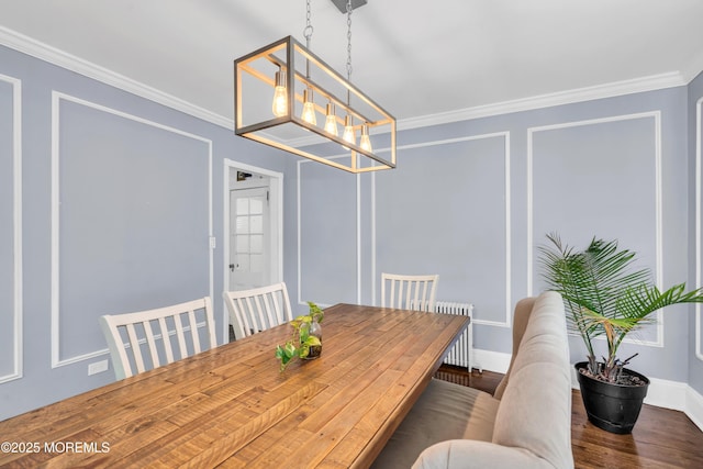 dining room with ornamental molding, wood finished floors, radiator, baseboards, and a chandelier