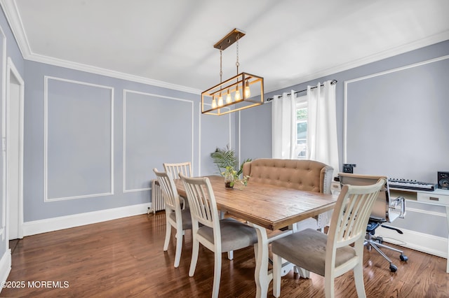 dining area featuring ornamental molding, a decorative wall, a chandelier, wood finished floors, and baseboards