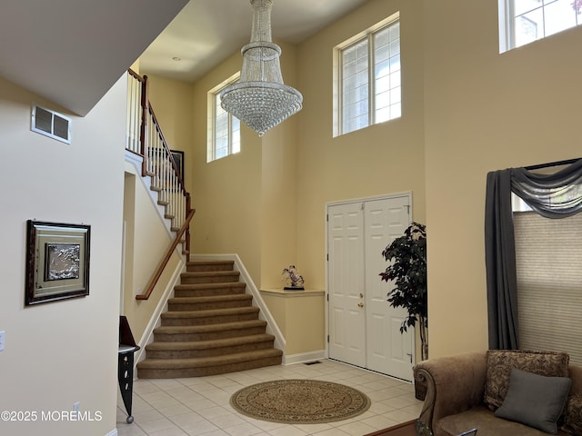 27 Stonehenge Ct, Jackson, NJ 08527 - entryway featuring a towering ceiling, stairway, tile patterned flooring, baseboards, and a chandelier