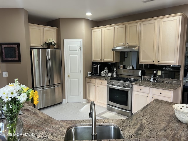 27 Stonehenge Ct, Jackson, NJ 08527 - kitchen featuring appliances with stainless steel finishes, a sink, light tile patterned flooring, under cabinet range hood, and dark stone counters