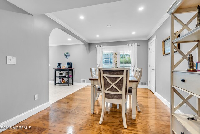 1012 Bismarck St, Toms River, NJ 08757 - dining room featuring ornamental molding, recessed lighting, light wood-type flooring, arched walkways, and baseboards