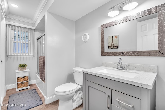1012 Bismarck St, Toms River, NJ 08757 - full bath featuring crown molding, vanity, wood finished floors, toilet, and enclosed tub / shower combo