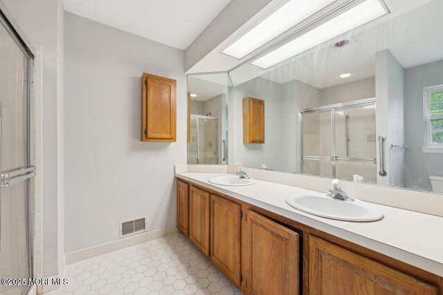 119 Morning Glory, Whiting, NJ 08759 - bathroom with a shower stall, double vanity, baseboards, and tile patterned floors