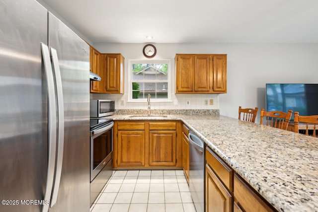 119 Morning Glory, Whiting, NJ 08759 - kitchen featuring appliances with stainless steel finishes, a sink, light tile patterned floors, and decorative backsplash
