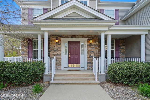 55 Freedom Hills Dr, Barnegat, NJ 08005 - doorway to property with covered porch and stone siding