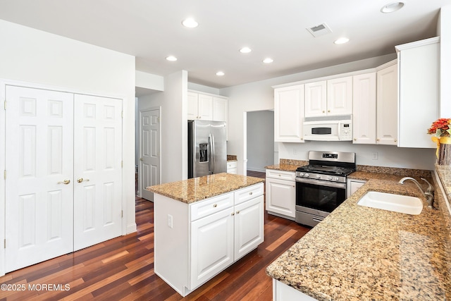 55 Freedom Hills Dr, Barnegat, NJ 08005 - kitchen with stainless steel appliances, a sink, a center island, dark wood-type flooring, and white cabinetry