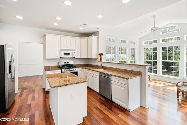 55 Freedom Hills Dr, Barnegat, NJ 08005 - kitchen featuring appliances with stainless steel finishes, a sink, a peninsula, a ceiling fan, and white cabinetry