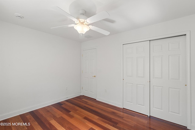 55 Freedom Hills Dr, Barnegat, NJ 08005 - unfurnished bedroom with dark wood finished floors, a closet, baseboards, and ceiling fan