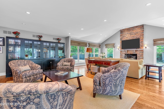 7 Seagull Ln, Lincroft, NJ 07738 - living room with vaulted ceiling, a stone fireplace, light wood-style floors, and recessed lighting
