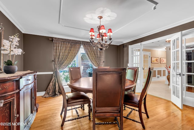 7 Seagull Ln, Lincroft, NJ 07738 - dining area with french doors, a chandelier, crown molding, and light wood-type flooring