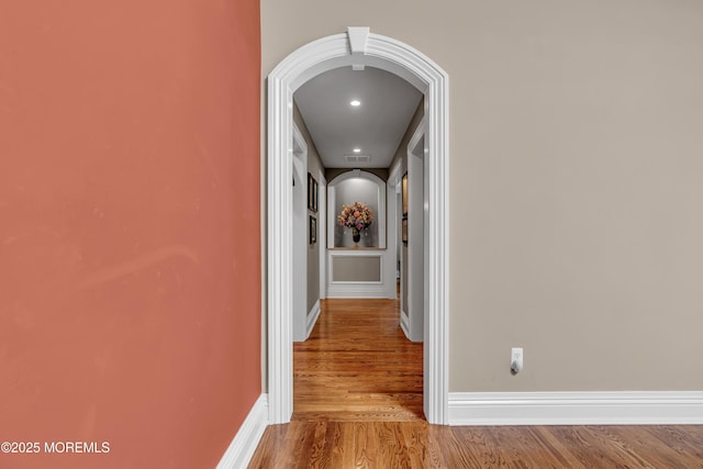 7 Seagull Ln, Lincroft, NJ 07738 - hall with arched walkways, wood finished floors, and baseboards
