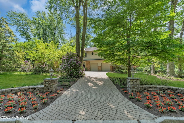 7 Seagull Ln, Lincroft, NJ 07738 - obstructed view of property featuring brick siding, a front lawn, decorative driveway, and a garage