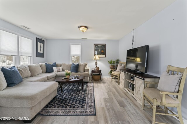 living room with light wood finished floors and baseboards