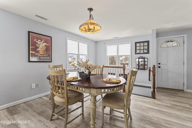 dining room featuring light wood-style floors and baseboards