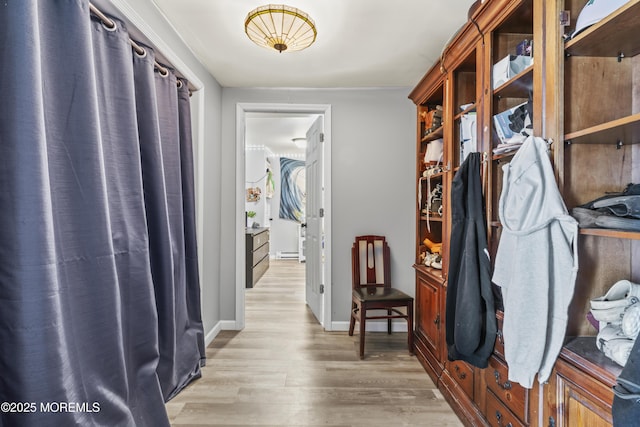 mudroom featuring light wood-type flooring, a baseboard radiator, and baseboards