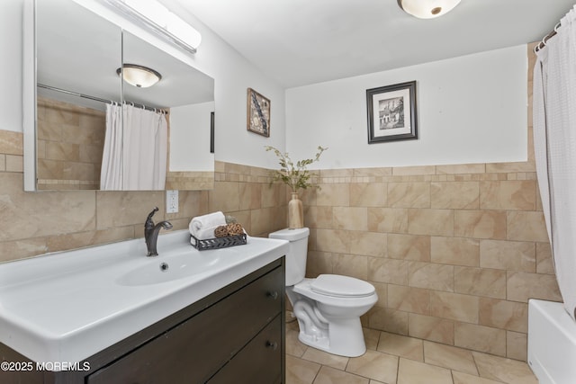 full bathroom with tile walls, vanity, tile patterned flooring, toilet, and a shower with shower curtain