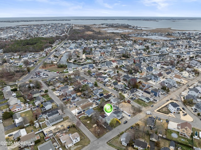 aerial overview of property's location featuring a large body of water and nearby suburban area