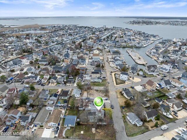 view of property location featuring a large body of water and nearby suburban area