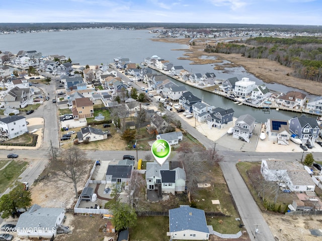 aerial view of property's location with a large body of water and nearby suburban area