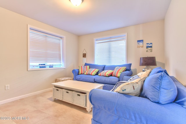 living area featuring baseboards