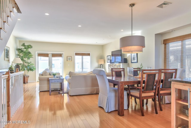 dining area featuring light wood-style flooring and recessed lighting