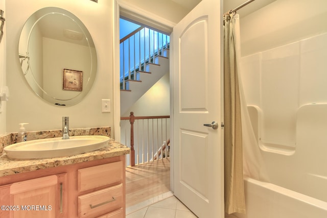 full bathroom featuring tile patterned floors, vanity, and shower / bathtub combination with curtain