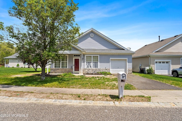 43 Osprey Pl, Barnegat, NJ 08005 - view of front of property featuring an attached garage, stone siding, a front yard, and asphalt driveway