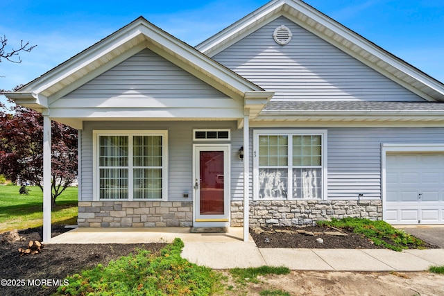 43 Osprey Pl, Barnegat, NJ 08005 - view of front facade featuring stone siding, a shingled roof, and an attached garage