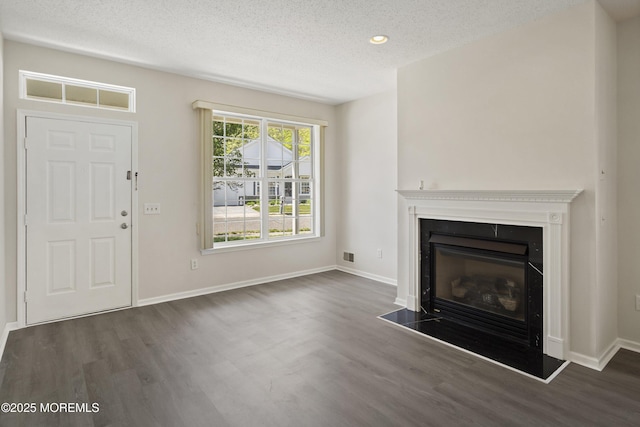 43 Osprey Pl, Barnegat, NJ 08005 - unfurnished living room with wood finished floors, a textured ceiling, a glass covered fireplace, baseboards, and recessed lighting