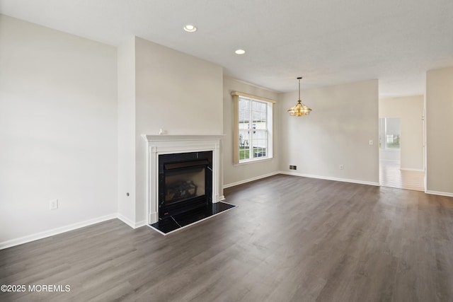 43 Osprey Pl, Barnegat, NJ 08005 - unfurnished living room with dark wood-type flooring, a fireplace, baseboards, a chandelier, and recessed lighting