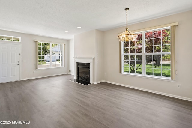 43 Osprey Pl, Barnegat, NJ 08005 - unfurnished living room featuring dark wood-type flooring, baseboards, a glass covered fireplace, a textured ceiling, and recessed lighting