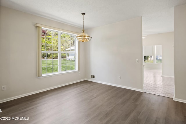 43 Osprey Pl, Barnegat, NJ 08005 - spare room featuring a chandelier, plenty of natural light, baseboards, dark wood-style flooring, and a textured ceiling