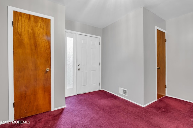 entrance foyer with carpet floors and baseboards