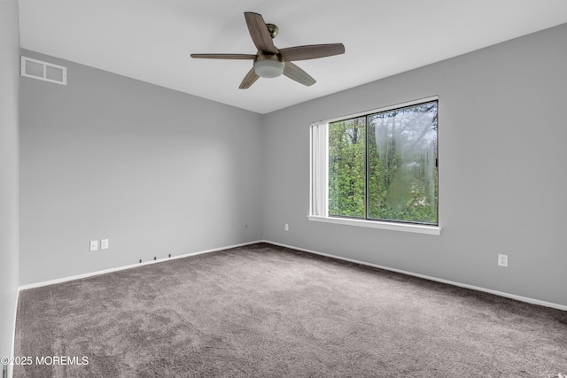 spare room with carpet flooring, ceiling fan, and baseboards