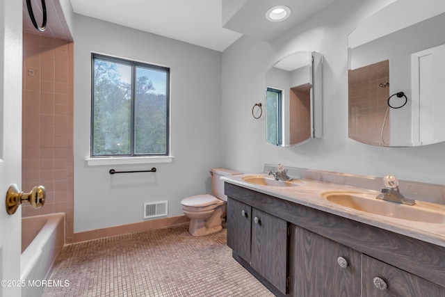 full bath with toilet and double vanity